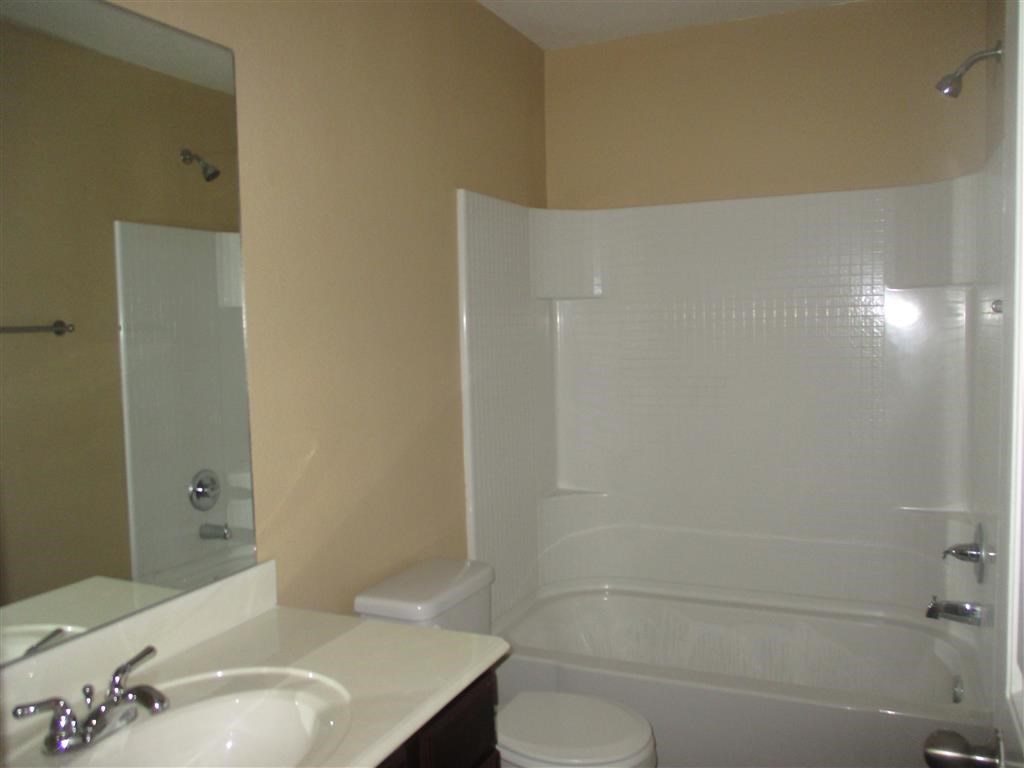 a bathroom with a sink toilet and a bath tub