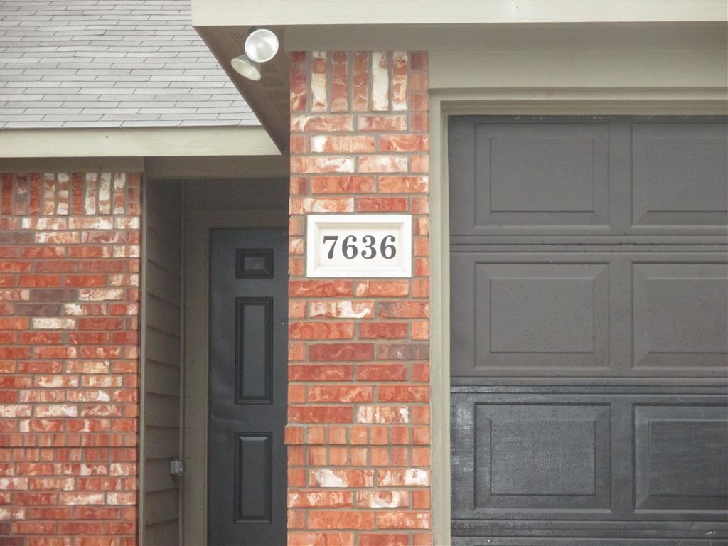 the front of a house with a black door