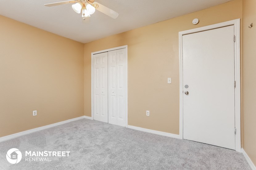 the upstairs bedroom has a closet and a ceiling fan