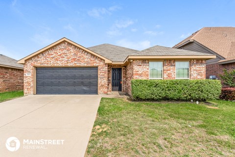 a brick house with a black garage door