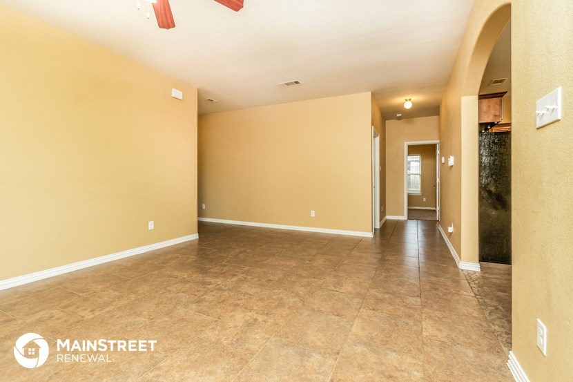 the spacious living room with tile flooring and yellow walls