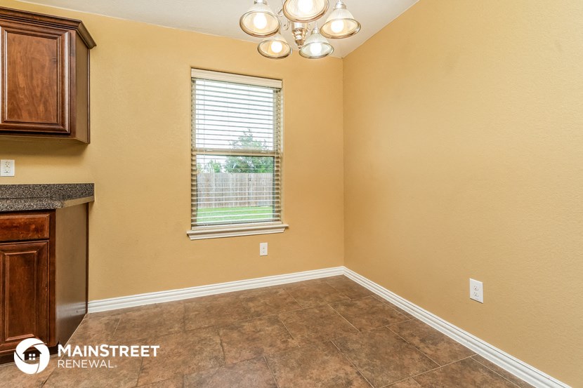 a dining room with a window and a table
