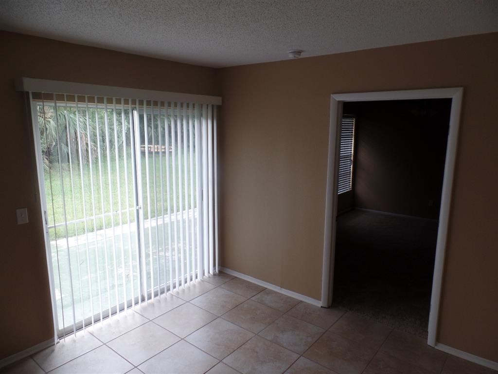 an empty living room with a sliding glass door