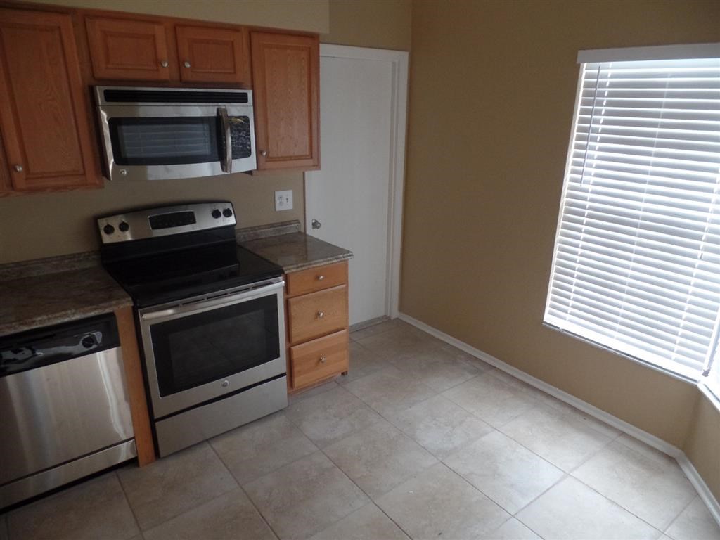 a kitchen with a stove and a microwave