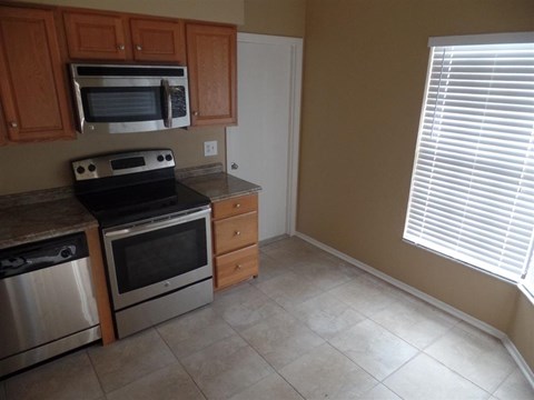 a kitchen with a stove and a microwave