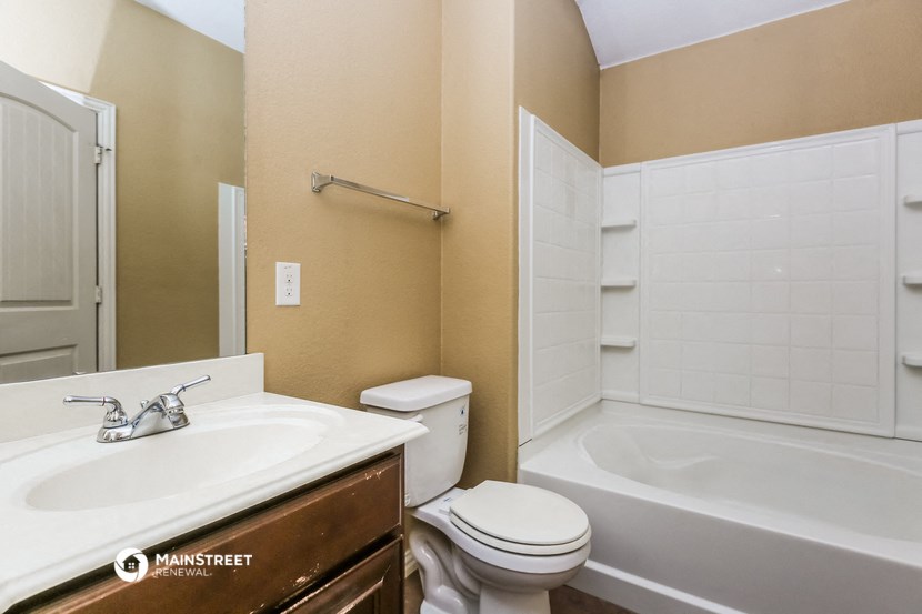 a bathroom with a sink toilet and a bath tub