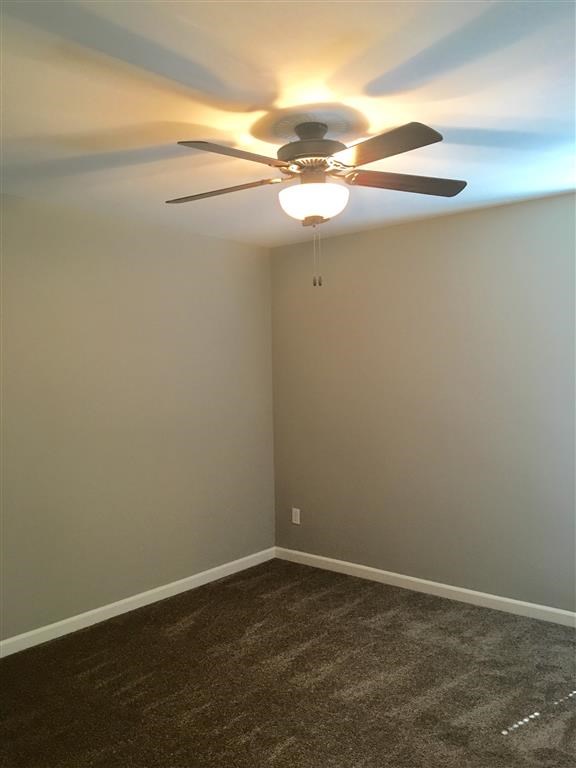 a room with a ceiling fan and a light