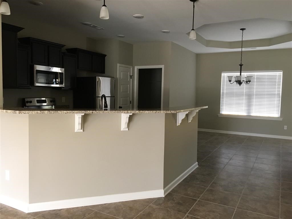 an empty kitchen with a counter top