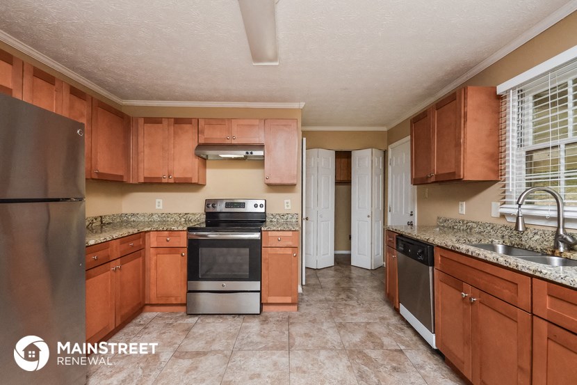 a kitchen with wooden cabinets and stainless steel appliances