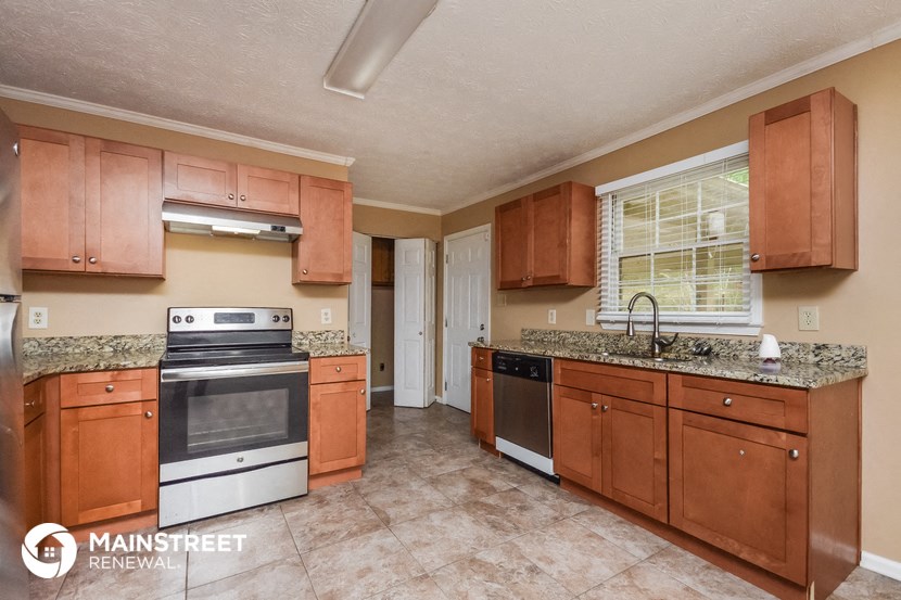 a kitchen with wooden cabinets and stainless steel appliances