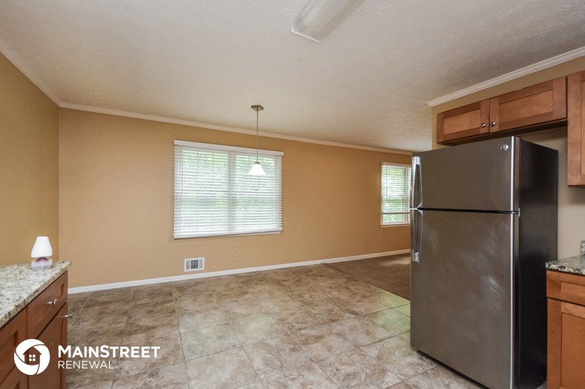 a kitchen with a stainless steel refrigerator and cabinets