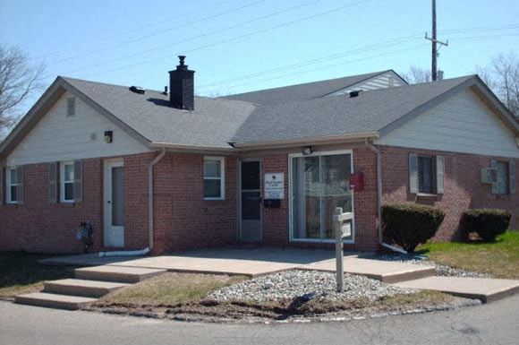 a brick house with a sign in the window
