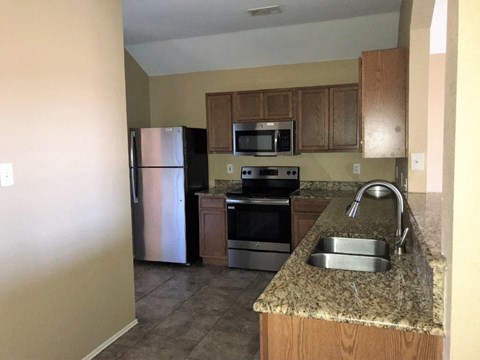 a kitchen with stainless steel appliances and a granite counter top