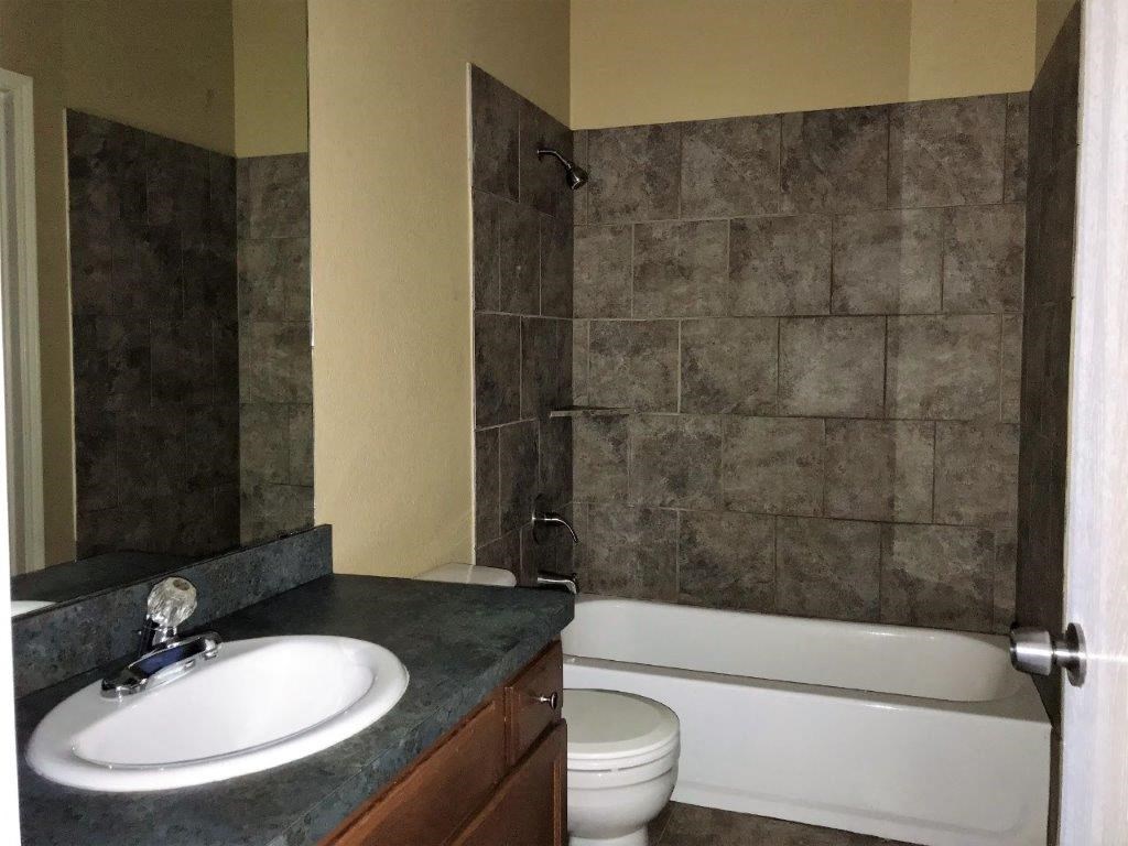 a bathroom with a sink toilet and a bath tub