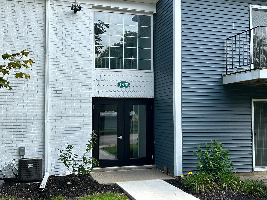 the front entrance of a building with a glass door