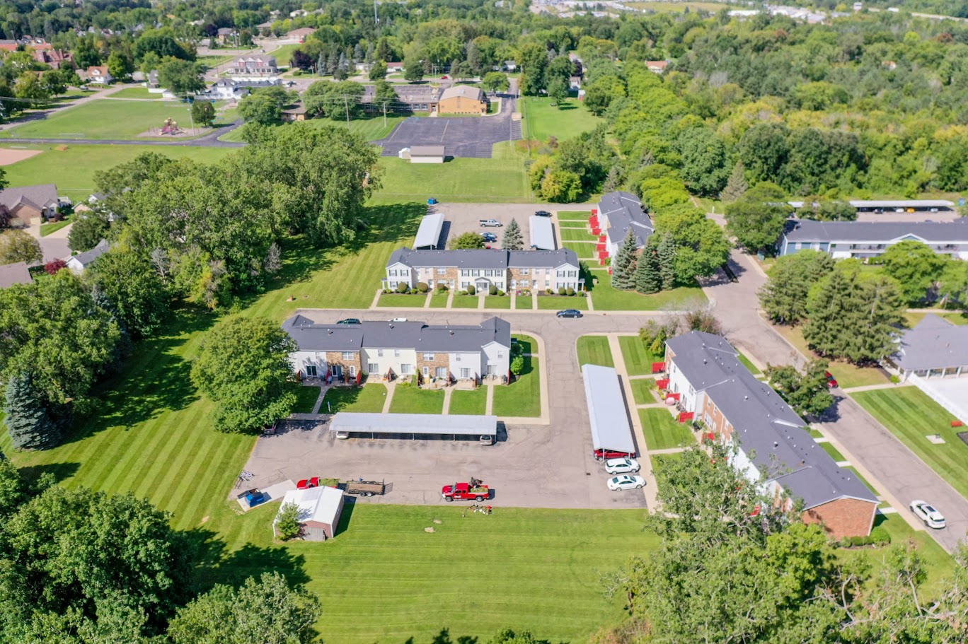 a view from above of a neighborhood of houses and a field