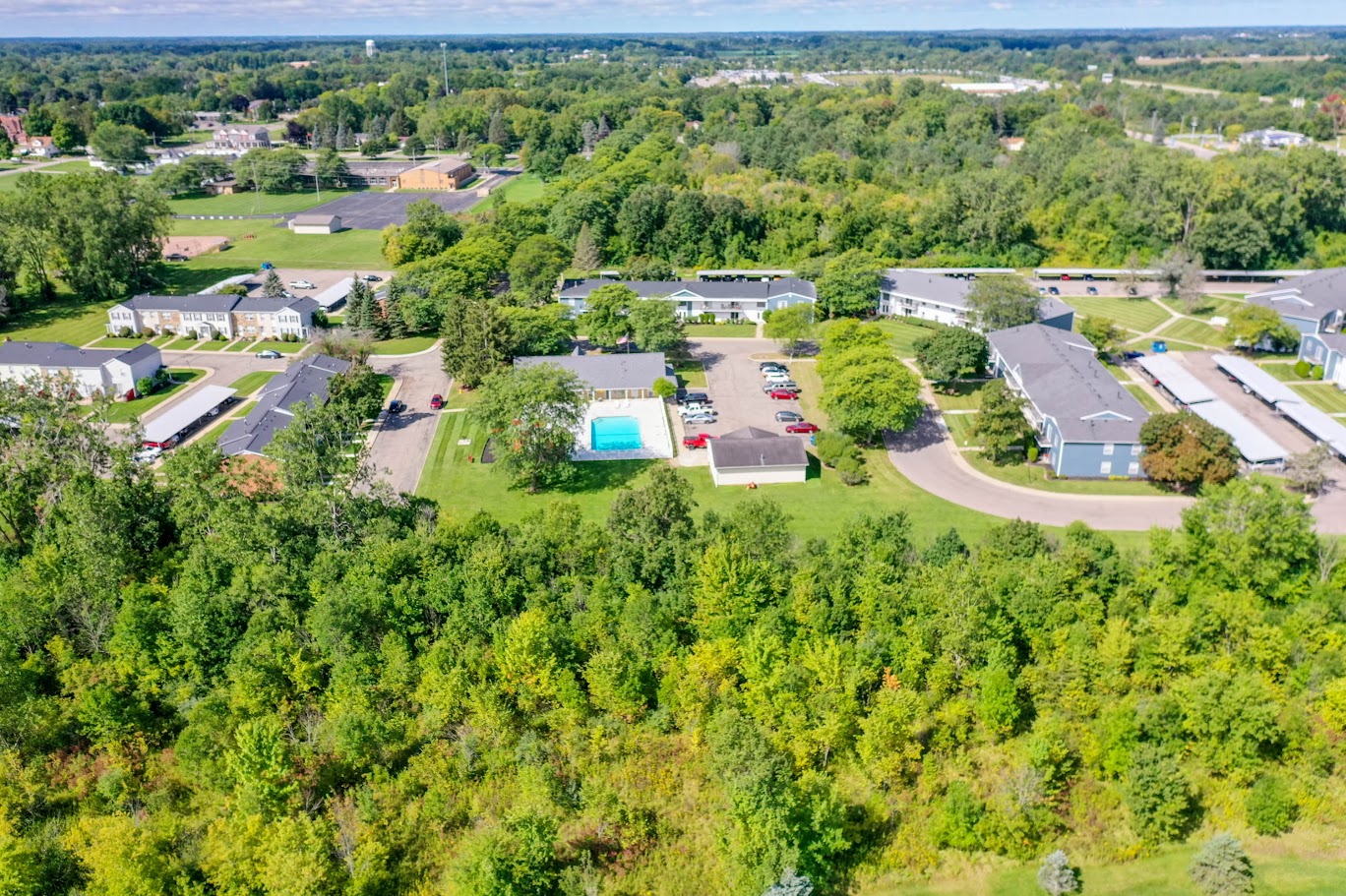 a aerial view of a neighborhood with houses and a swimming pool