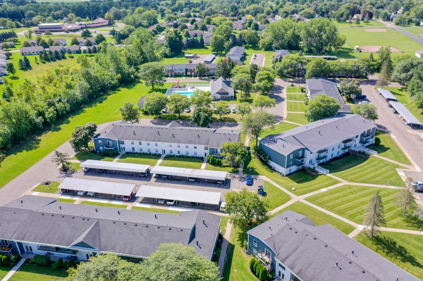 an aerial view of a group of buildings and a field