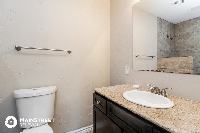 a bathroom with a sink and a mirror and a toilet
