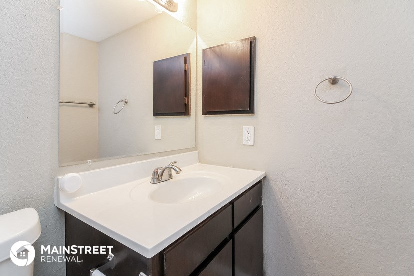 a bathroom with a sink and a mirror and a toilet