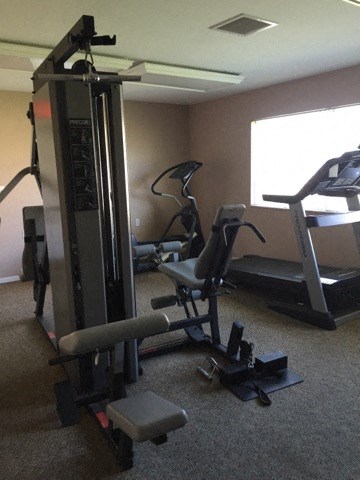 a gym with some machines in a room