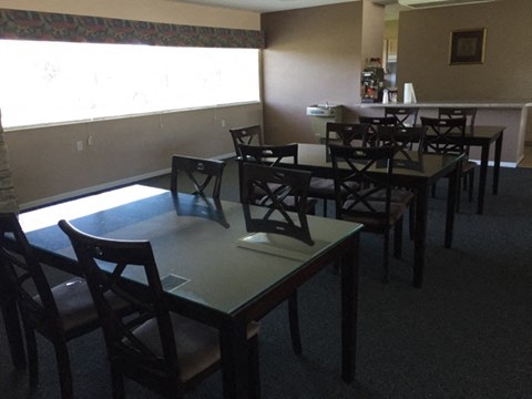 a dining room with tables and chairs and a window