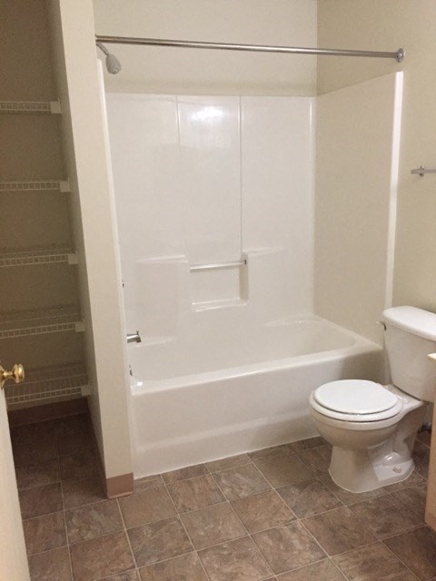 a bathroom with a toilet and a bath tub