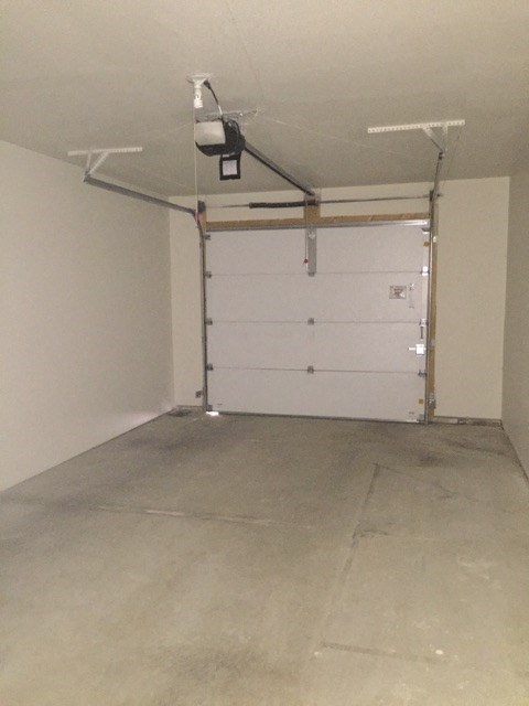 an empty garage with a white garage door