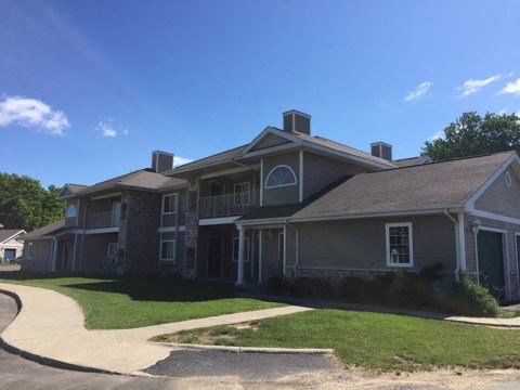 a large house with a sidewalk in front of it