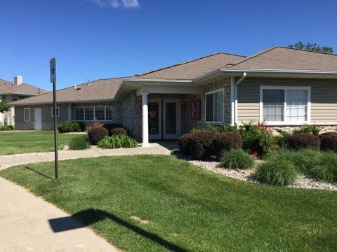 a house with a yard and a street sign in front of it