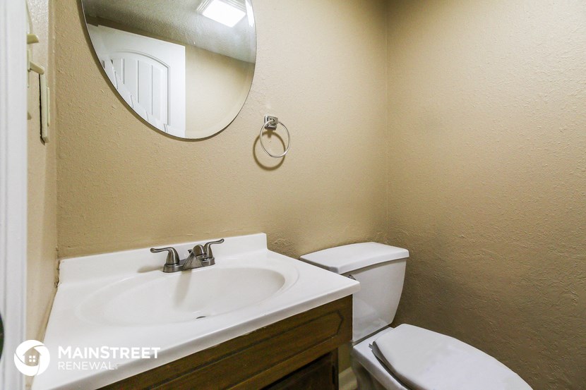 a bathroom with a sink and a toilet and a mirror
