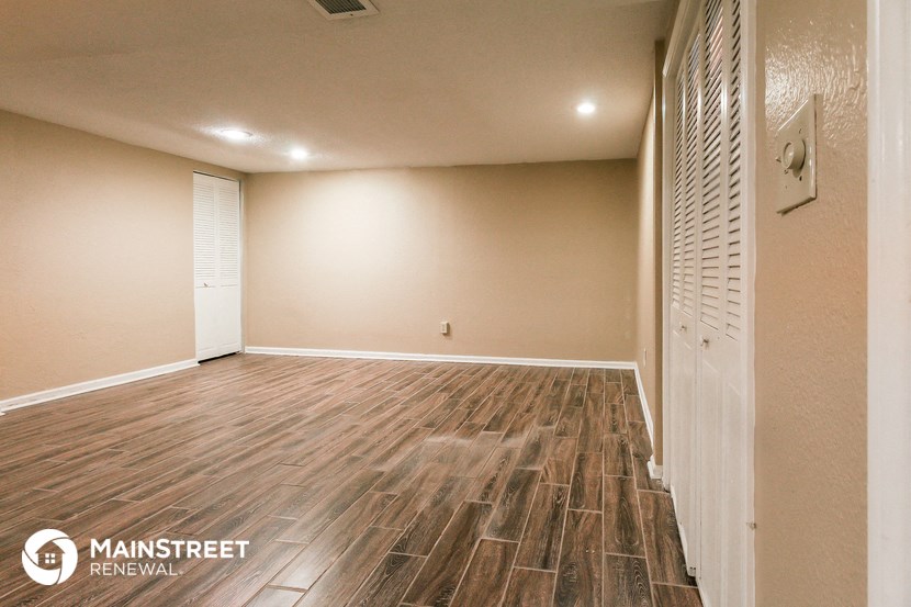a living room with wood flooring and a white door