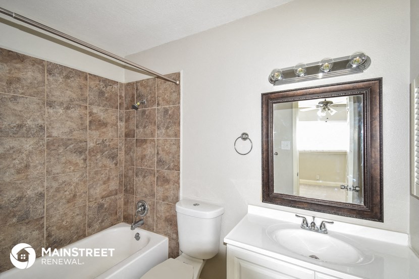 a bathroom with a sink toilet and a mirror