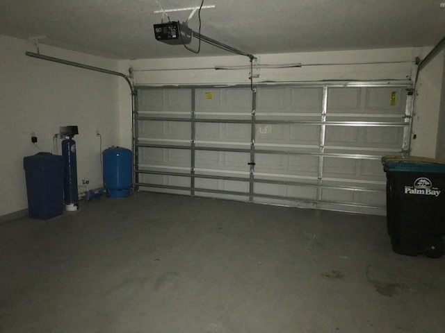 the inside of a garage with a white door