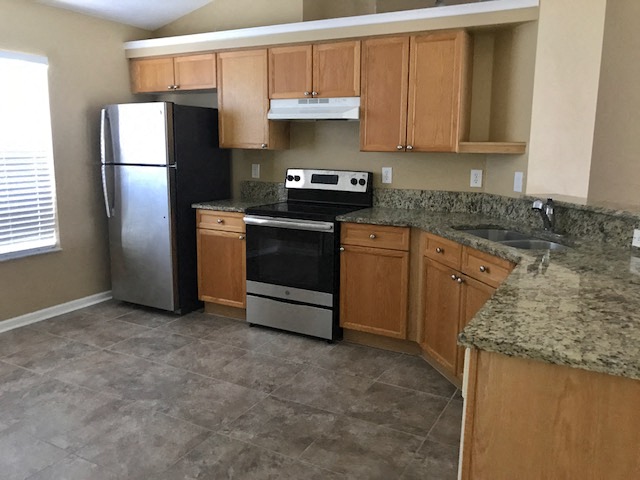 a kitchen with a stove and a refrigerator