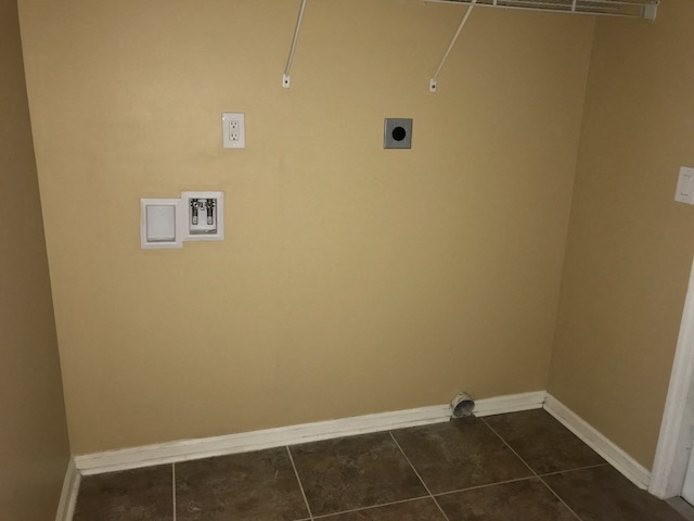 a wall with two outlets and a speaker in a room