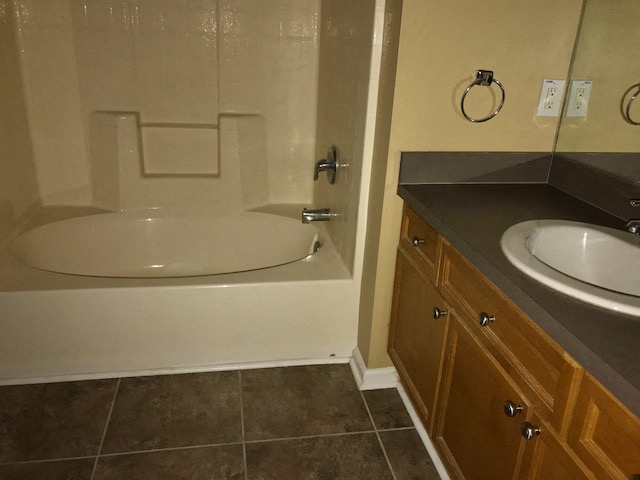 a bathroom with a sink and a bath tub