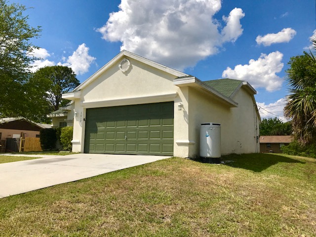 a white house with a green garage door