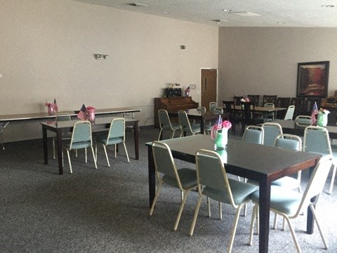 a large room with tables and chairs and chairs