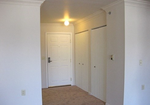 an empty room with a door and a light on the ceiling