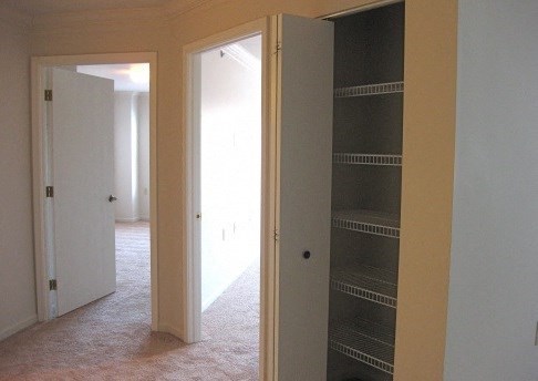 an empty room with a closet and two doors