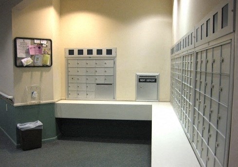 a bank of lockers with mailboxes and a television