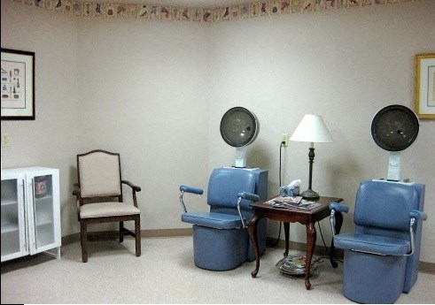a living room with blue chairs and a table
