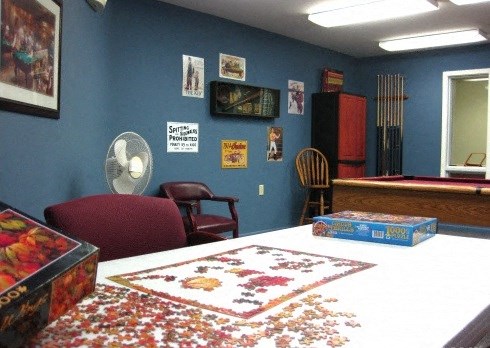 a blue room with a table and a red chair