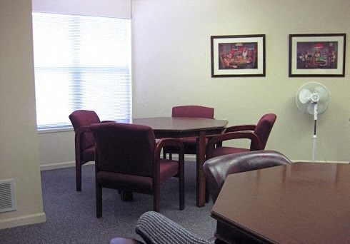 a dining room with a table and chairs