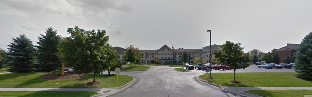 the parking lot of a building with cars parked in front of it