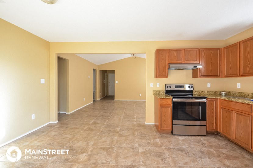 a kitchen with wooden cabinets and a stove and a sink