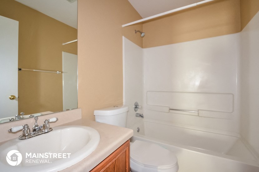 a bathroom with a sink and a toilet and a tub