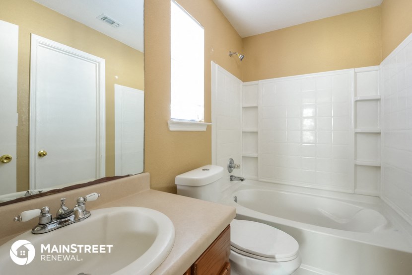 a bathroom with a sink and a toilet and a bath tub