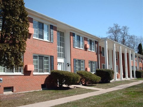 a large brick building with white columns